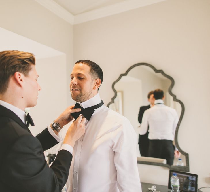 Groom Helping His Husband Tie His Bow Tie on the Wedding Morning