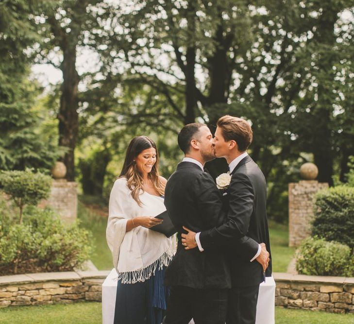 Groom and Groom Kissing  at Outdoor Wedding Ceremony at Worcestershire Wedding Venue Foxhill Manor