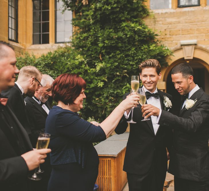 Groomsmen in Tuxedo 'Cheers' with Wedding Guests