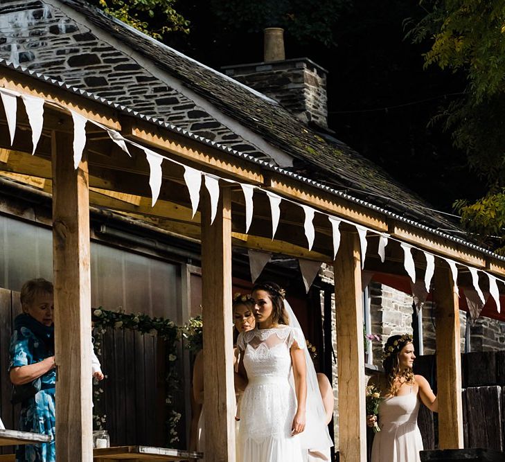 Arrival of the Bride | Laced KatyaKatya Wedding Dress with Cap Sleeves and Ribbon Belt | Floor Length Veil | Bridesmaids in Dusty Pink ASOS Dresses | Flower Crowns | White Bunting | Lace KatyaKatya Dress for Tipi Wedding at Fforest Farm | Claudia Rose Carter Photography