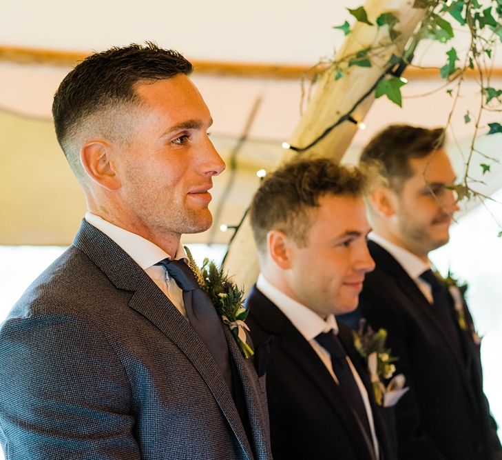 Wedding Ceremony | Groom in Blue T.M Lewin Suit with Navy Hawkes Bespoke Outfitters Waistcoat | Groomsmen in Navy Moss Bros. Suits | Lace KatyaKatya Dress for Tipi Wedding at Fforest Farm | Claudia Rose Carter Photography