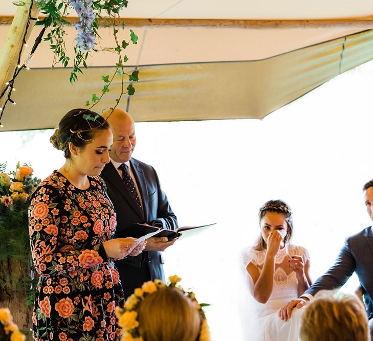 Wedding Ceremony Emotions | Bride in Laced KatyaKatya Wedding Dress with Cap Sleeves and Ribbon Belt | Groom in Blue T.M Lewin Suit with Navy Hawkes Bespoke Outfitters Waistcoat | Lace KatyaKatya Dress for Tipi Wedding at Fforest Farm | Claudia Rose Carter Photography