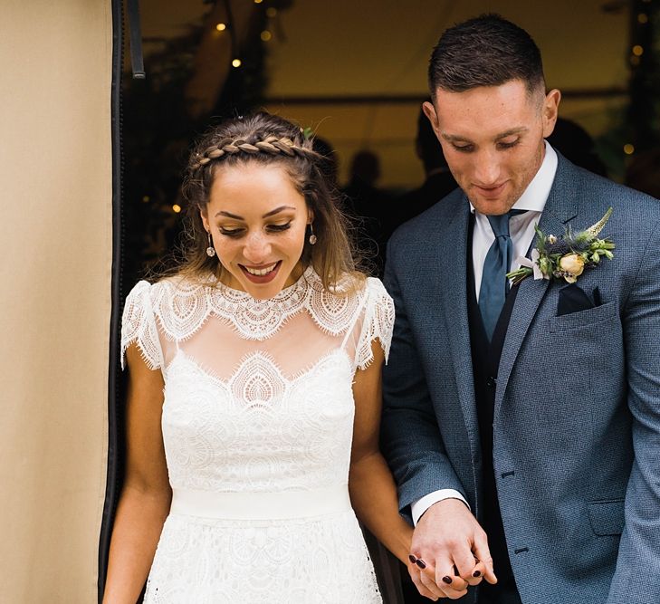 Just Married | Bride in Laced KatyaKatya Wedding Dress with Cap Sleeves and Ribbon Belt | Groom in Blue T.M Lewin Suit with Navy Hawkes Bespoke Outfitters Waistcoat | Lace KatyaKatya Dress for Tipi Wedding at Fforest Farm | Claudia Rose Carter Photography