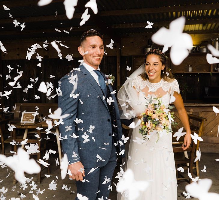 Confetti Cannon | Bride in Laced KatyaKatya Wedding Dress with Cap Sleeves and Ribbon Belt | Groom in Blue T.M Lewin Suit with Navy Hawkes Bespoke Outfitters Waistcoat | Bridal Bouquet of Wild Flowers  with Lavender, Thistles, White Roses and Eucalyptus | Lace KatyaKatya Dress for Tipi Wedding at Fforest Farm | Claudia Rose Carter Photography