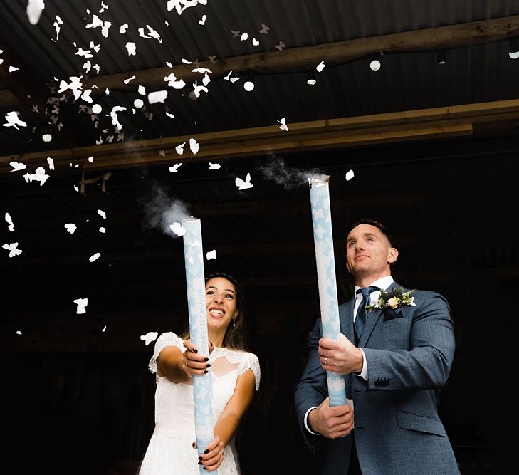 Confetti Cannons | Bride in Laced KatyaKatya Wedding Dress with Cap Sleeves and Ribbon Belt | Groom in Blue T.M Lewin Suit with Navy Hawkes Bespoke Outfitters Waistcoat | Bridal Bouquet of Wild Flowers  with Lavender, Thistles, White Roses and Eucalyptus | Lace KatyaKatya Dress for Tipi Wedding at Fforest Farm | Claudia Rose Carter Photography