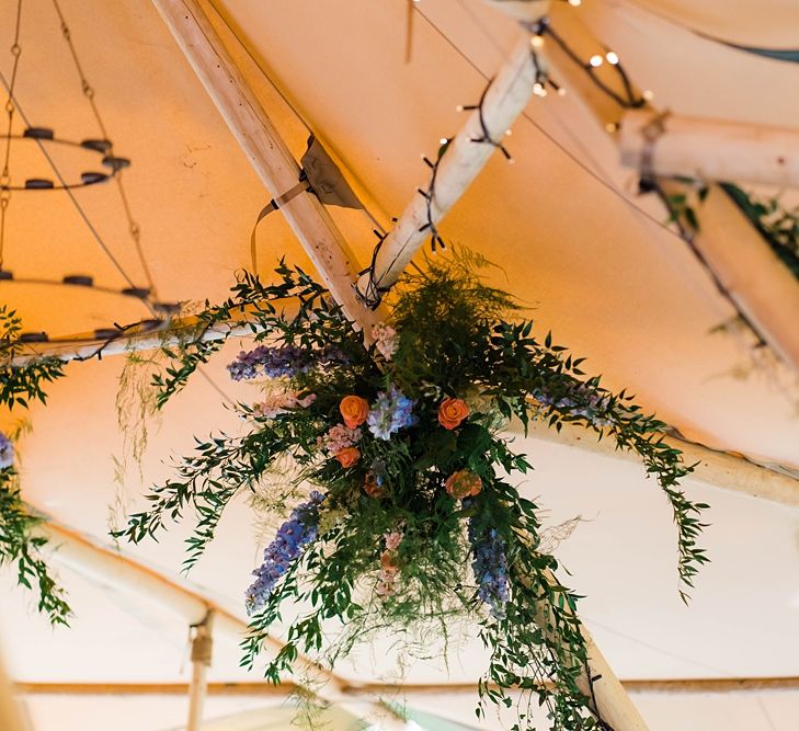 Wedding Reception Decor | Hanging Floral Installation in Tipi | Lace KatyaKatya Dress for Tipi Wedding at Fforest Farm | Claudia Rose Carter Photography