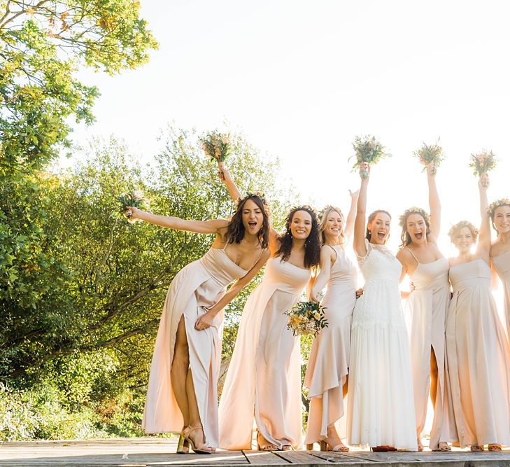 Bride in Laced KatyaKatya Wedding Dress with Cap Sleeves and Ribbon Belt | Bridesmaids in Dusty Pink ASOS Dresses | Flower Crowns | Mixed Wild Flower Bouquets with Daisys, Lavender and White Roses | Lace KatyaKatya Dress for Tipi Wedding at Fforest Farm | Claudia Rose Carter Photography