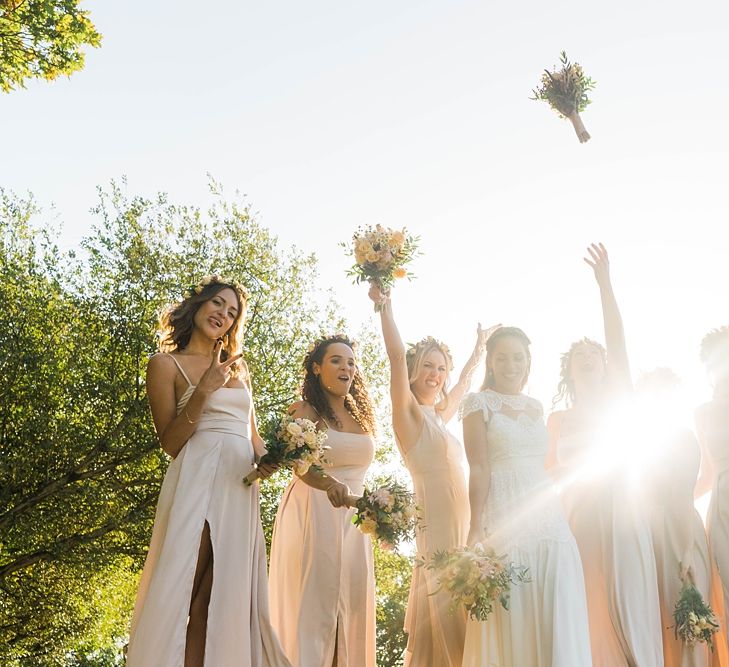 Bride in Laced KatyaKatya Wedding Dress with Cap Sleeves and Ribbon Belt | Bridesmaids in Dusty Pink ASOS Dresses | Flower Crowns | Mixed Wild Flower Bouquets with Daisys, Lavender and White Roses | Lace KatyaKatya Dress for Tipi Wedding at Fforest Farm | Claudia Rose Carter Photography