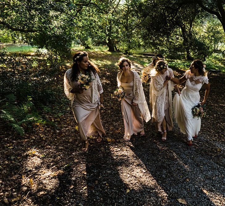 Bride in Laced KatyaKatya Wedding Dress with Cap Sleeves and Ribbon Belt | Bridesmaids in Dusty Pink ASOS Dresses  and White ASOS Kaftans | Flower Crowns | Mixed Wild Flower Bouquets with Daisys, Lavender and White Roses | Lace KatyaKatya Dress for Tipi Wedding at Fforest Farm | Claudia Rose Carter Photography