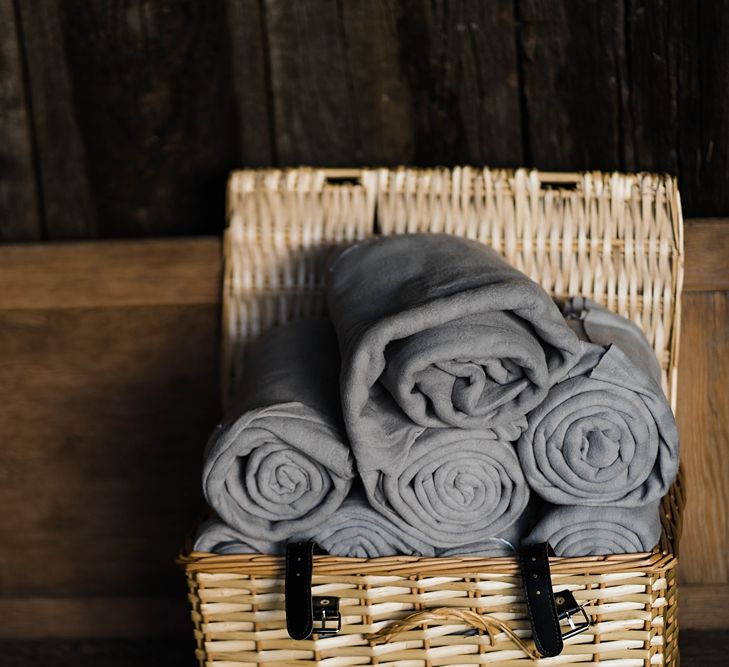 Wedding Reception Decor | Grey Blankets in Wicker Basket | Lace KatyaKatya Dress for Tipi Wedding at Fforest Farm | Claudia Rose Carter Photography