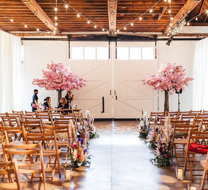 Pink blossom trees and vibrant florals at dry hire wedding venue