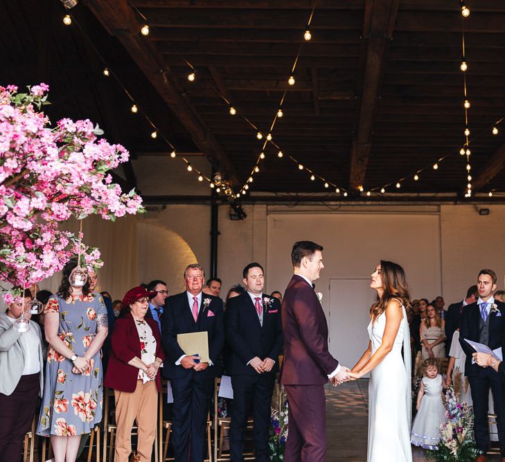 Dry hire wedding venue with festoon lighting and pink blossom trees