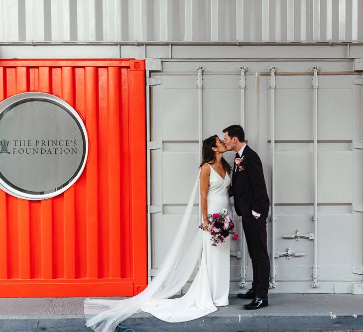 Bride and groom embrace at London celebration