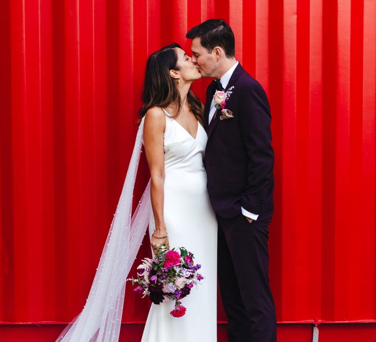 Bridal dress with laced side panels and polka dot train