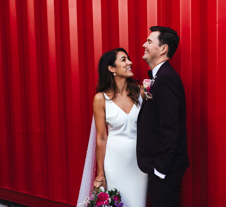 Bride and groom at London celebration with vibrant styling