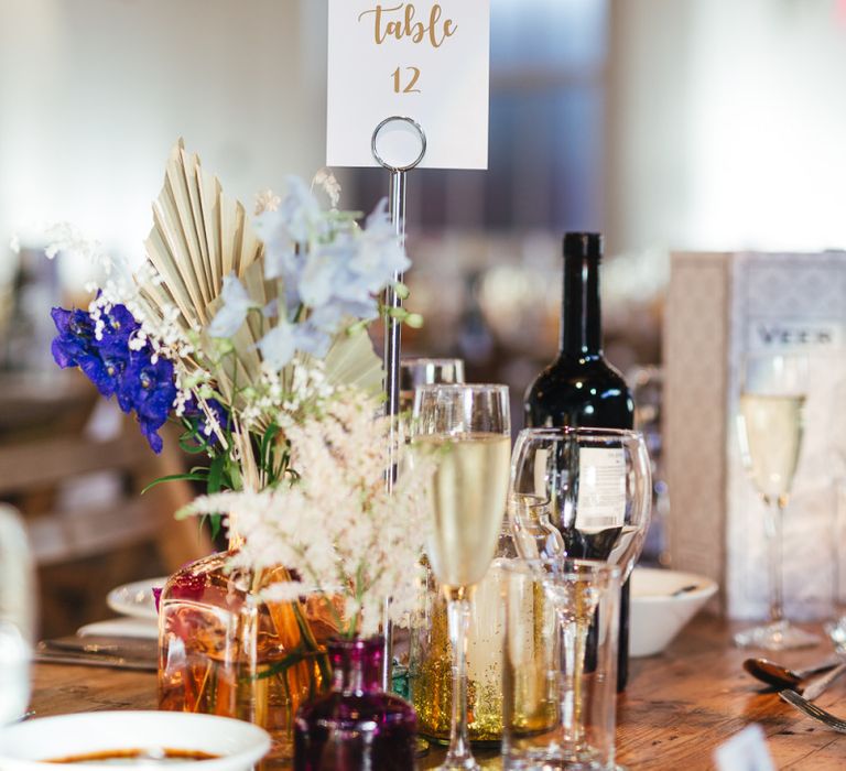 Table numbers and floral table arrangements at dry hire wedding venue