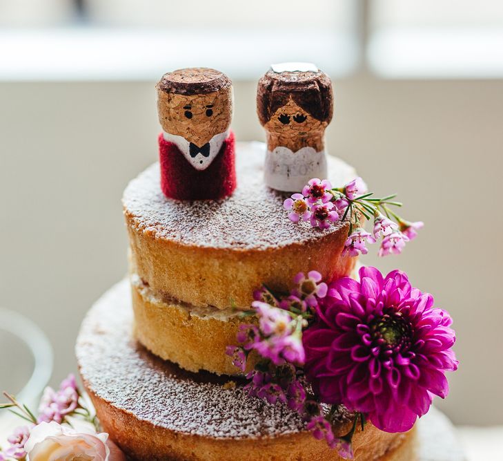 Bride &amp; Groom cork cake toppers with vibrant floral decoration