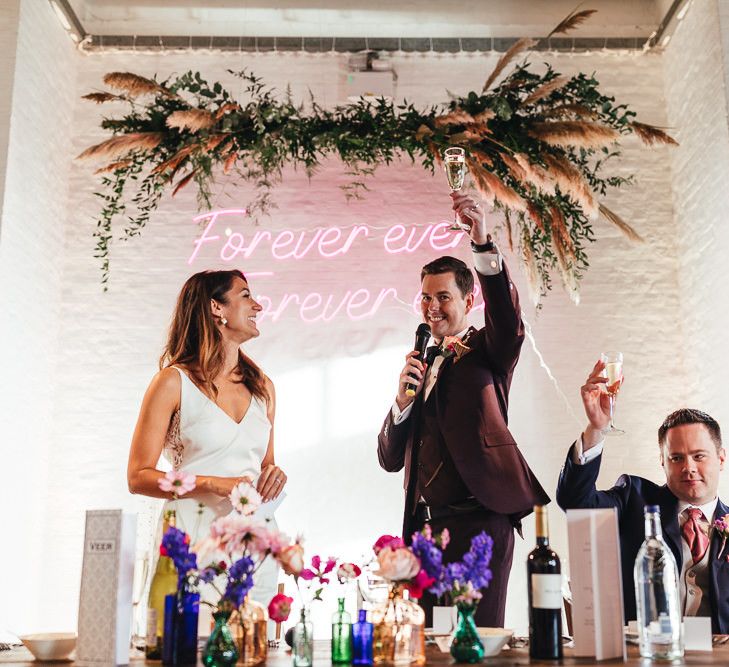 Raise a glass at industrial style reception with personalised neon sign