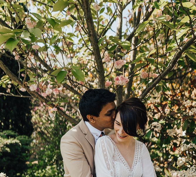 Groom embracing his bride in Rosa Clara wedding dress