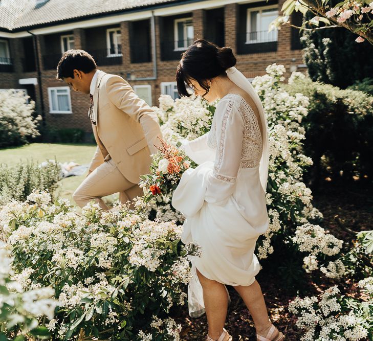 Bride and groom holding hands