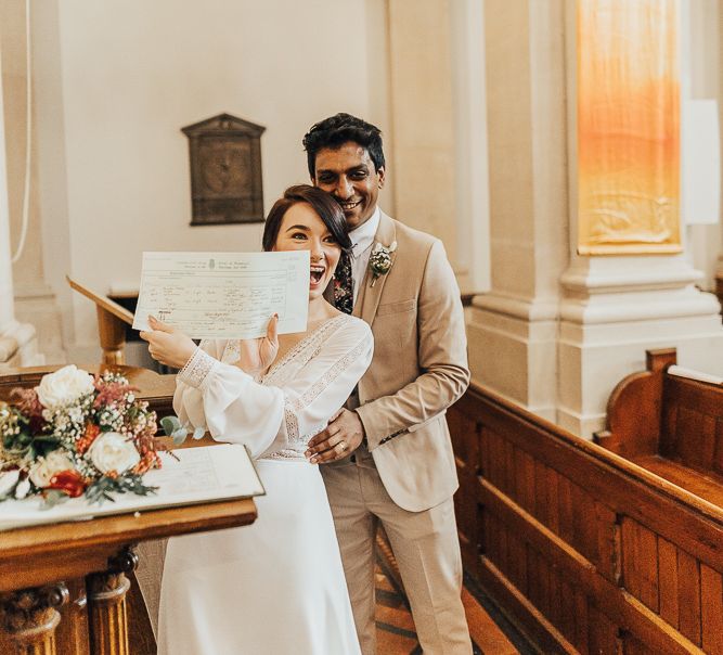 NHS nurse and doctor show their marriage certificate