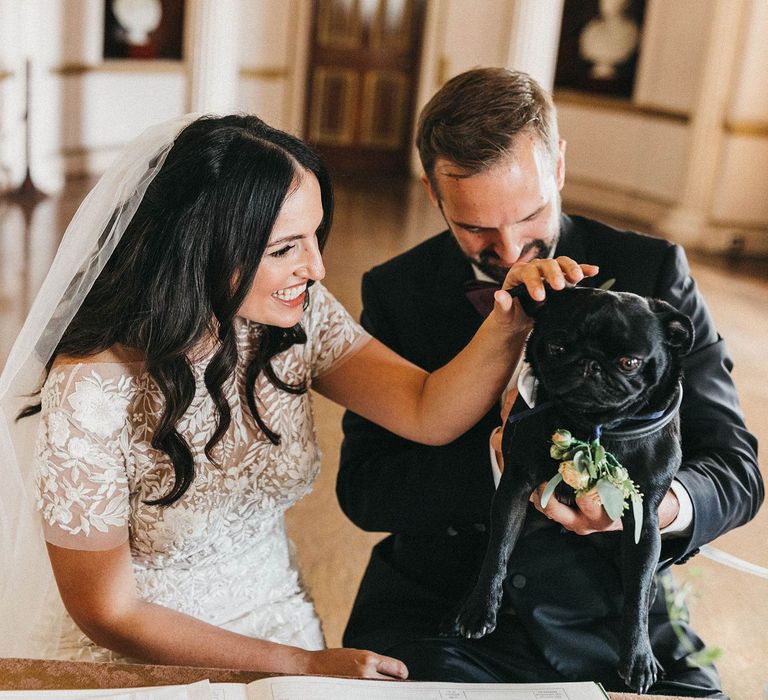 Signing of the Register | Bride in Hermione de Paula Wedding Gown with Short Sleeves and Personalised Embroidery | Cathedral Veil | Groom in Navy Lanvin Tuxedo and Black Burberry Shoes | Burgundy Bow Tie | Paul the Pug | Stunning Syon Park Wedding with Quill Stationery Suite | Nancy Ebert Photography