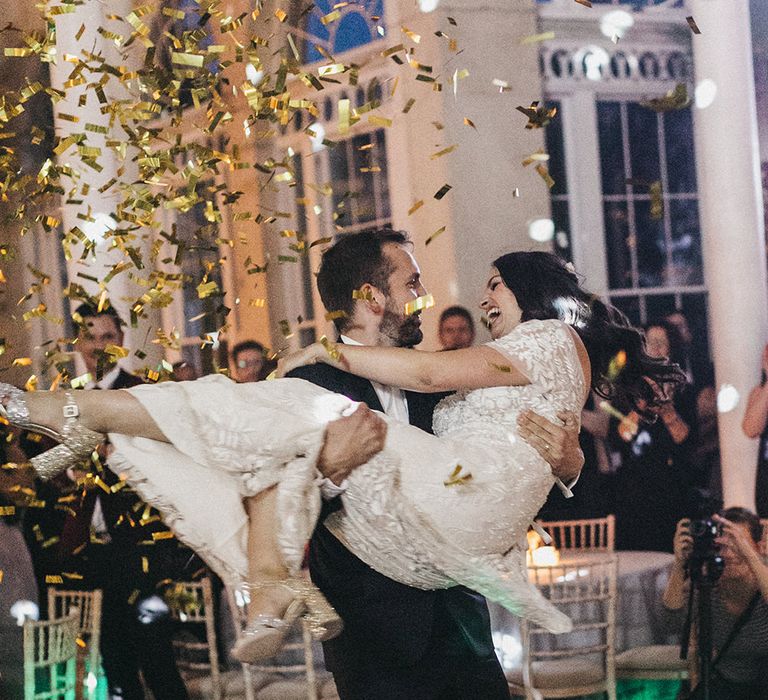 First Dance | Gold Confetti Cannon | MiuMiu Glitter Block Heels | Bride in Hermione de Paula Wedding Gown with Short Sleeves and Personalised Embroidery | Groom in Navy Lanvin Tuxedo and Black Burberry Shoes | Burgundy Bow Tie | Stunning Syon Park Wedding with Quill Stationery Suite | Nancy Ebert Photography