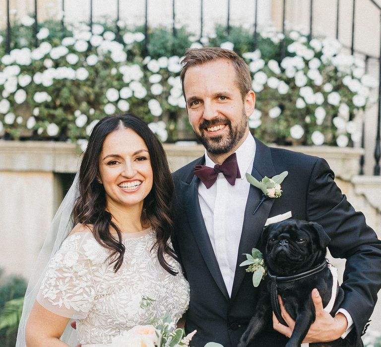 Bride in Hermione de Paula Wedding Gown with Short Sleeves and Personalised Embroidery | Cathedral Veil | Groom in Navy Lanvin Tuxedo and Black Burberry Shoes | Burgundy Bow Tie | Blush, Cream and Pink Bridal Bouquet | Paul the Pug | Stunning Syon Park Wedding with Quill Stationery Suite | Nancy Ebert Photography