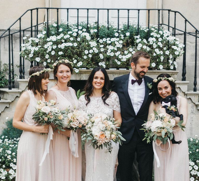 Bride in Hermione de Paula Wedding Gown with Short Sleeves and Personalised Embroidery | Bridesmaids in Blush Pink Dresses by Adrianna Papell | Bridesmaid in Blush Pink Jenny Packham for Debenhams Dress | Groom in Navy Lanvin Tuxedo and Black Burberry Shoes | Burgundy Bow Tie | Blush, Cream and Pink Bouquets | Paul the Pug | Stunning Syon Park Wedding with Quill Stationery Suite | Nancy Ebert Photography