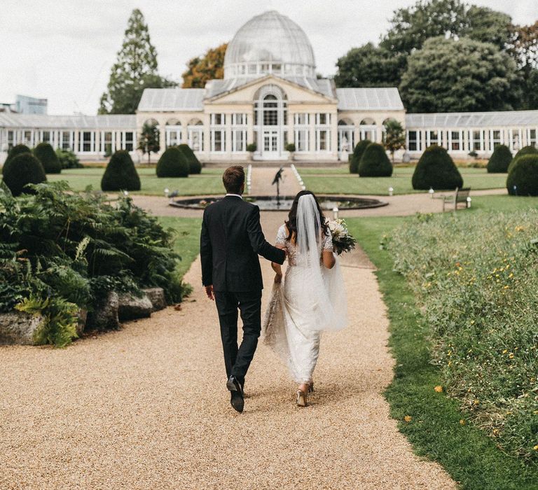 The Great Conservatory at Syon Park | Bride in Hermione de Paula Wedding Gown with Short Sleeves and Personalised Embroidery | Cathedral Veil | Groom in Navy Lanvin Tuxedo and Black Burberry Shoes | Burgundy Bow Tie | Blush, Cream and Pink Bridal Bouquet | Stunning Syon Park Wedding with Quill Stationery Suite | Nancy Ebert Photography