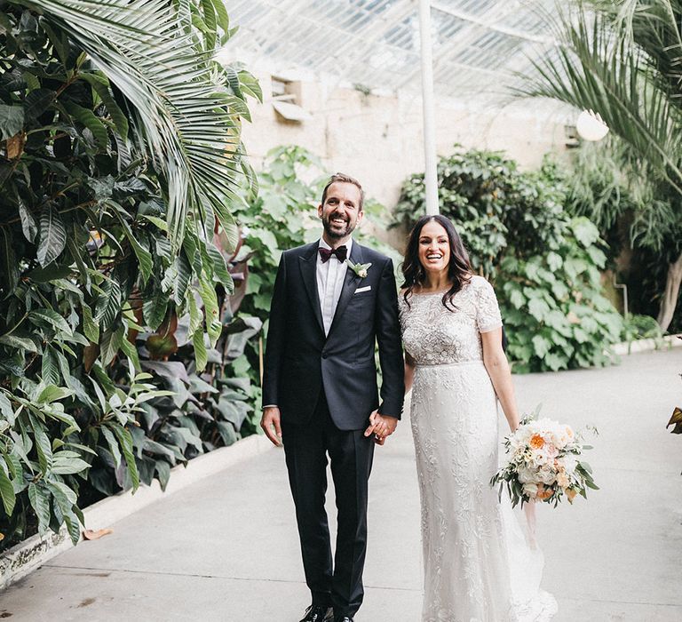 Bride in Hermione de Paula Wedding Gown with Short Sleeves and Personalised Embroidery | Cathedral Veil | Groom in Navy Lanvin Tuxedo and Black Burberry Shoes | Burgundy Bow Tie | Blush, Cream and Pink Bridal Bouquet | Stunning Syon Park Wedding with Quill Stationery Suite | Nancy Ebert Photography