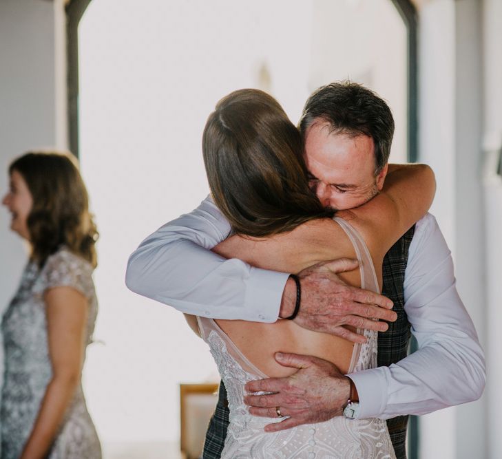 Father hugs bride before ceremony