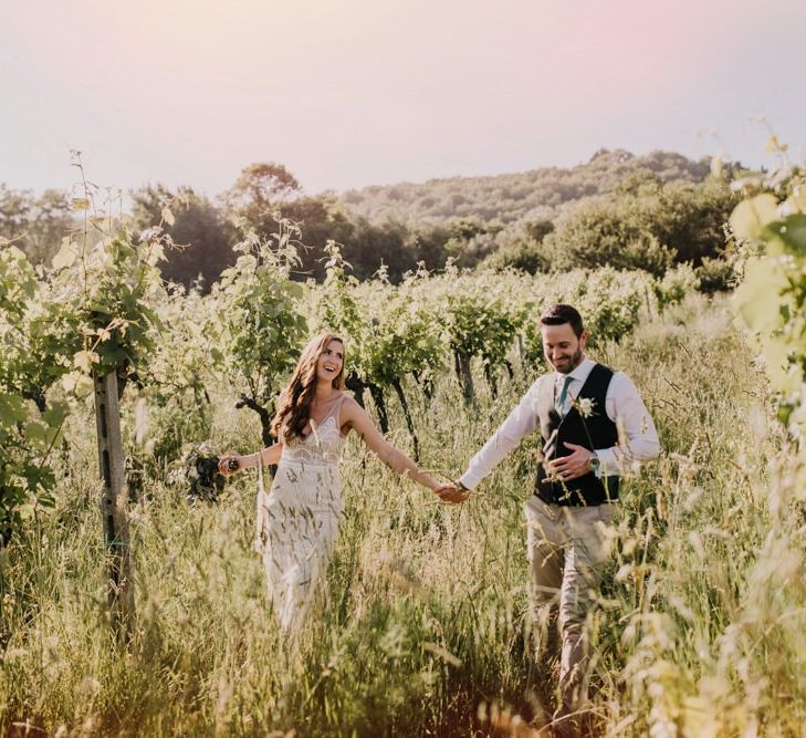 Bride and groom in the olive groves that inspired the bridesmaid dresses in mint green