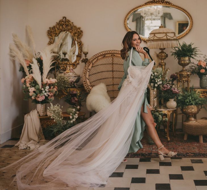 Bride in Green Getting Ready Rob Holding Her Wedding Dress