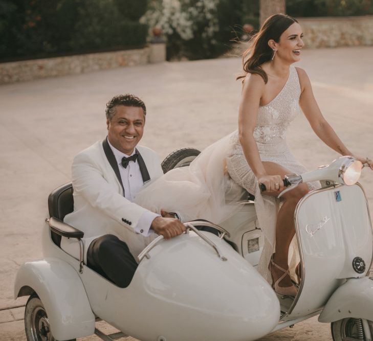 Stylish Bride and Groom Riding a Vespa on a Side Car