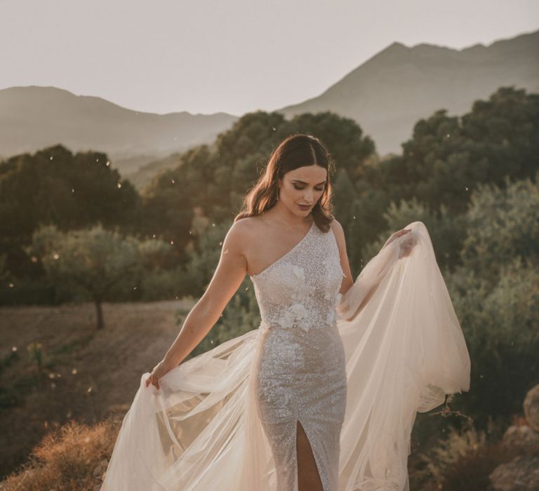 Bride in One Shoulder Muse by Berta Wedding Dress with Front Split and Tulle Train