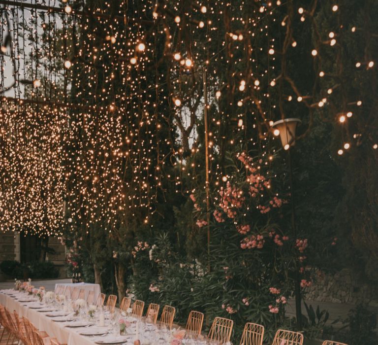 Long Trestle Wedding Breakfast Table with Fairy Light Canopy and Copper Chairs