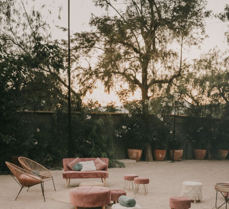 Chill Out Area with Blush Velvet Love Seats and Poufs and Wicker Chairs