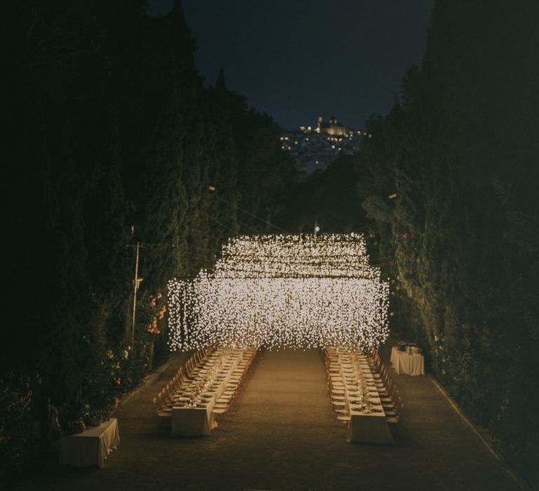 Outdoor Wedding Reception with Fairy Light Canopy and Chandelier Feature Table Plan at Marqués de Montemolar in Spain