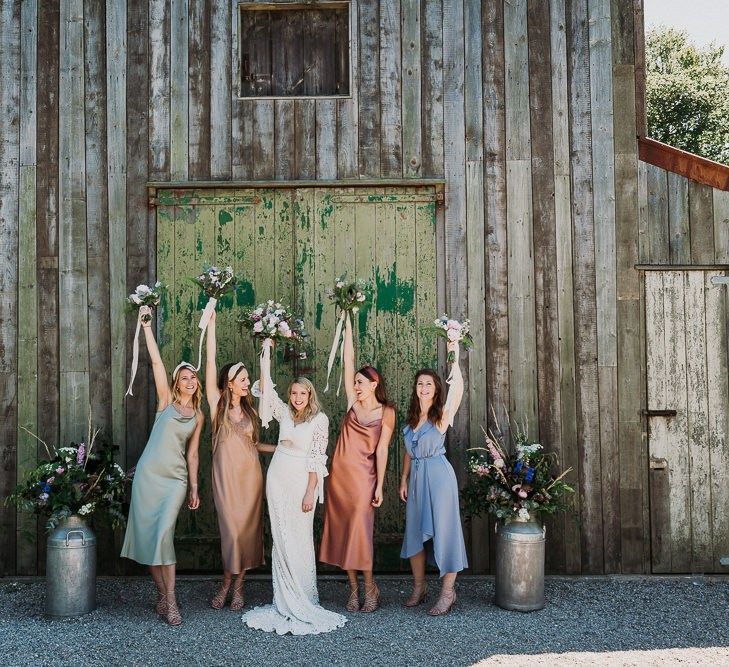 Bride and Bridesmaids in different coloured bridesmaid dresses