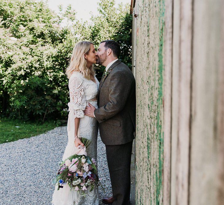 Bride and Groom with Wedding Bouquet and Tweed Suit