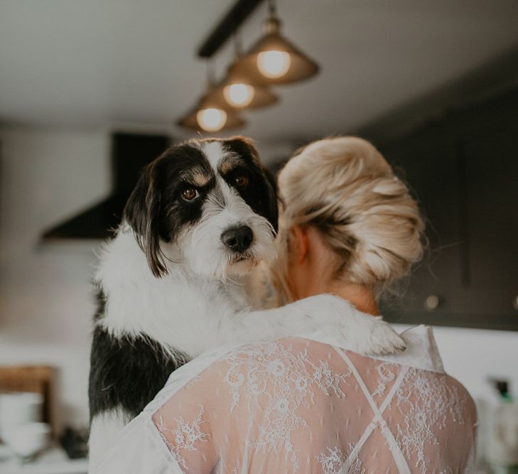 Bride has a cuddle with beloved pet pooch whilst getting ready