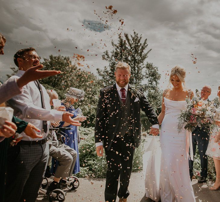 Confetti exit for bride and groom at small wedding