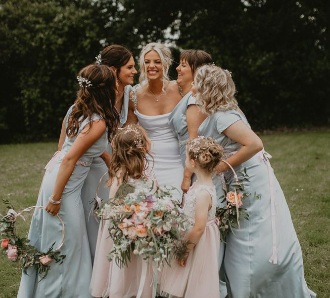 Blue bridesmaid dresses and pink flower girls with hoop bouquets