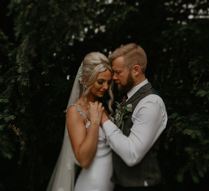 Bride and groom with embroidered veil with personalised stitching