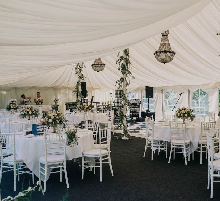 Foliage Garlands Wrapped Around Marquee Poles | Table Centrepieces of Blush and White Flowers with Foliage in Gold Urns | Marquee at Chateau La Durantie, Dordogne | Outdoor Seating Area and Macaroon Tower at French Chateau Wedding | Lush Imaging