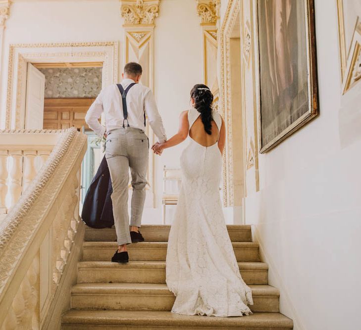 Bride in Lace Boat Neck Pronovias Wedding Dress with Keyhole Back and Fishtail Train | Groom in Navy Jacket, Grey Trousers and White Shirt with Pink Tie from Suit Supply | Chateau La Durantie, Dordogne | Outdoor Seating Area and Macaroon Tower at French Chateau Wedding | Lush Imaging