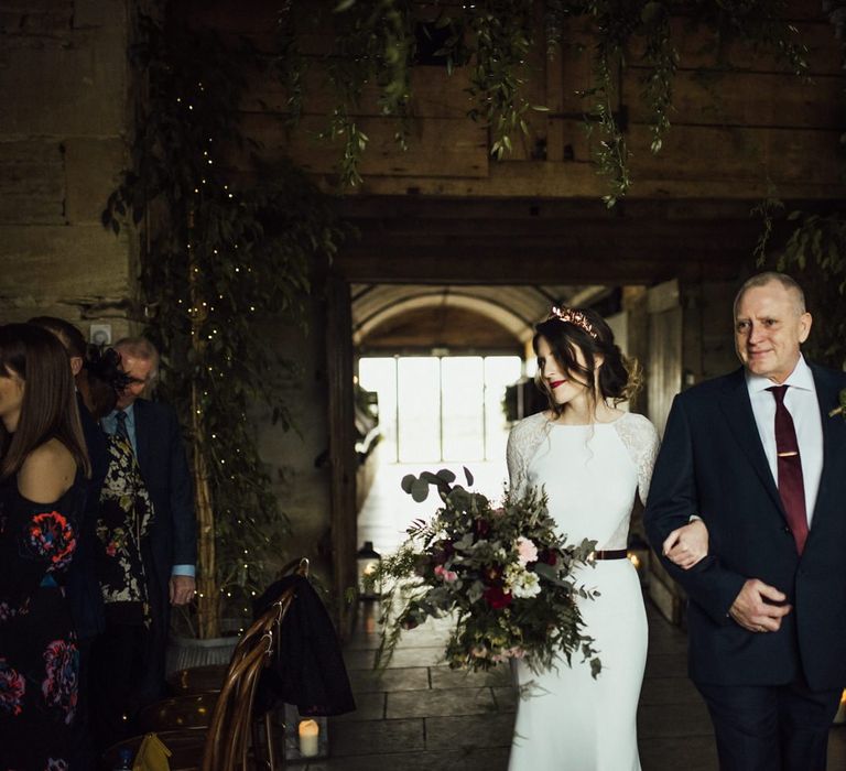 Stone Barn Wedding Ceremony Bridal Entrance in Fitted Wedding Dress with Lace Long Sleeves and Foliage Bouquet