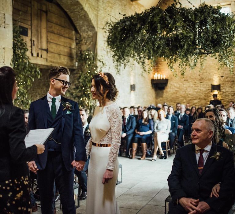 Bride and Groom Standing at Stone Barn Wedding Ceremony Holding Hands