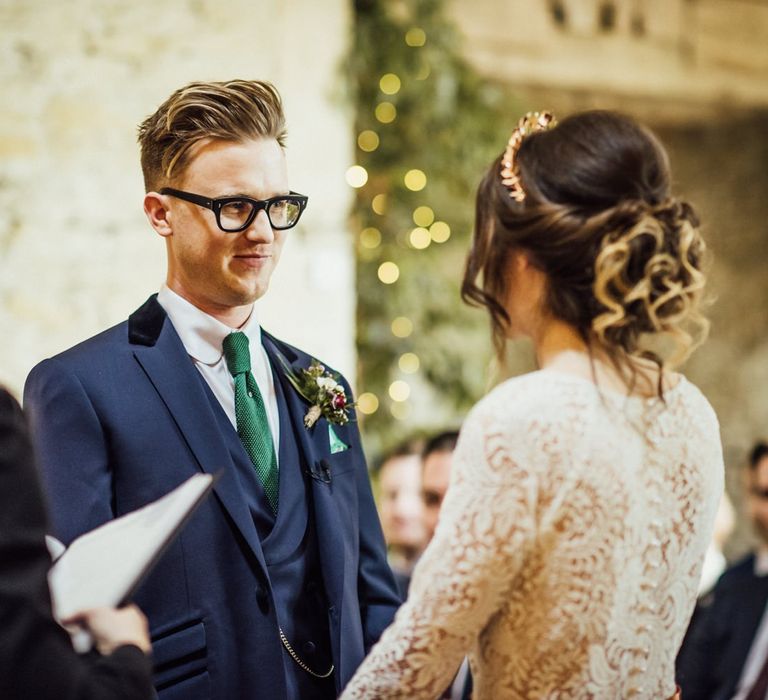 Bride and Groom Standing at Stone Barn Wedding Ceremony Holding Hands Exchanging Vows